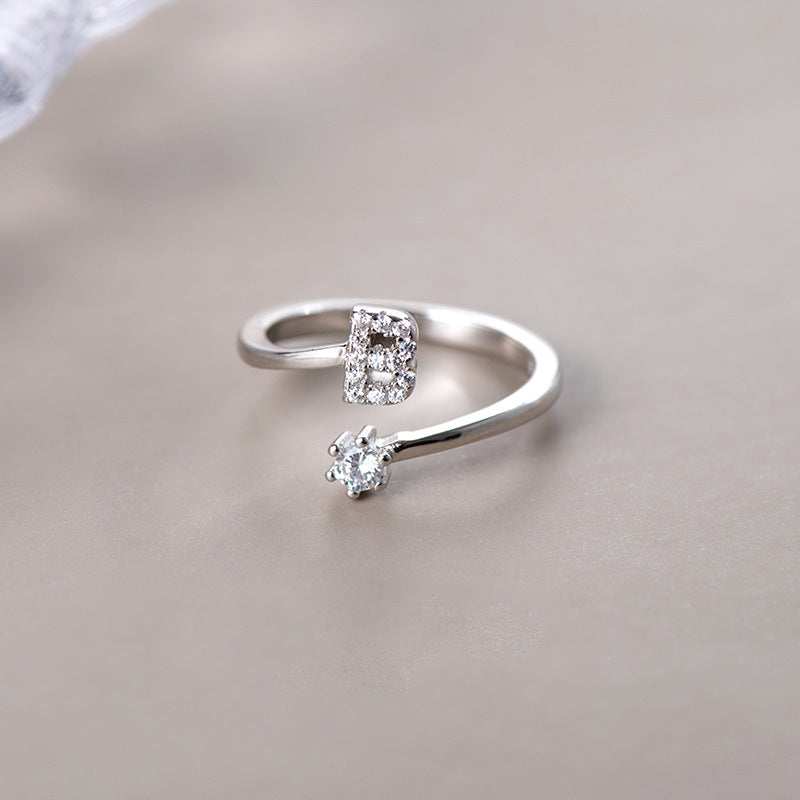 anel letra cravejada